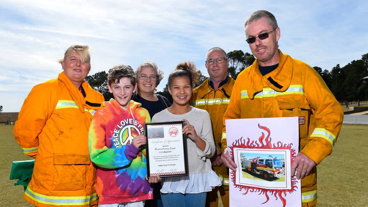 DONATION: Haddon Primary School captains Isabella Louw and Kiarn Dark with members of the Haddon CFA after students, many of whom were impacted by last week's Bunkers Hill bushfire, decided to donate money to the CFA instead of holding an end-of-term icecream party. Picture: Adam Trafford
