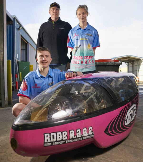 ROAD TRIP: Road RAGE team member Sam Dutli, 15, sponsor Paperfreight operations manager Greg Benfield and Bec McColl, 16, inspect their human-powered vehicle before heading north to Queensland. Picture: Luka Kauzlaric