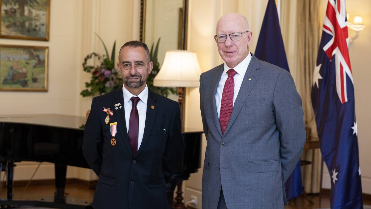 Nick Prince receives the Florence Nightingale Medal from Australia's Governor General David Hurley. Picture supplied