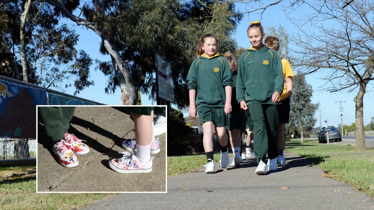 WALKIES: Warrenheip Primary grade six students Alisha and Olivia and classmates take a walk around the school after decorating their shoes (inset). Pictures: Kate Healy