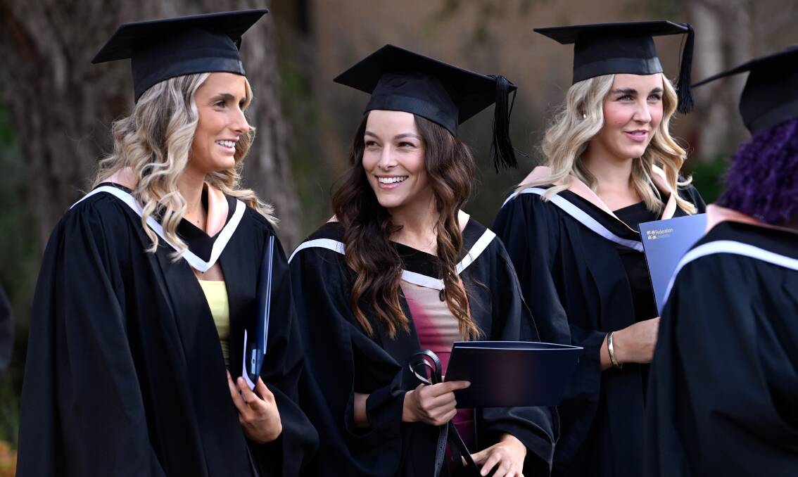 Students celebrate after graduating from Federation University. Picture by Adam Trafford
