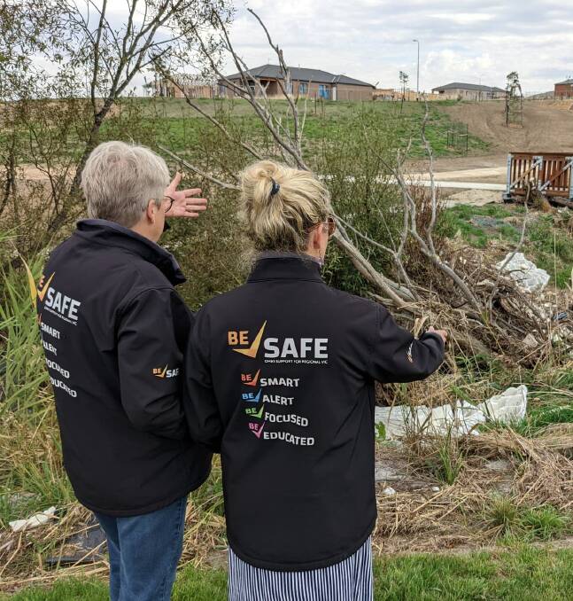 LITTERED: Tracey Brown and Lana Cormie inspect building rubbish dumped in the creek near the Workers Memorial in Delacombe. Pictures: supplied