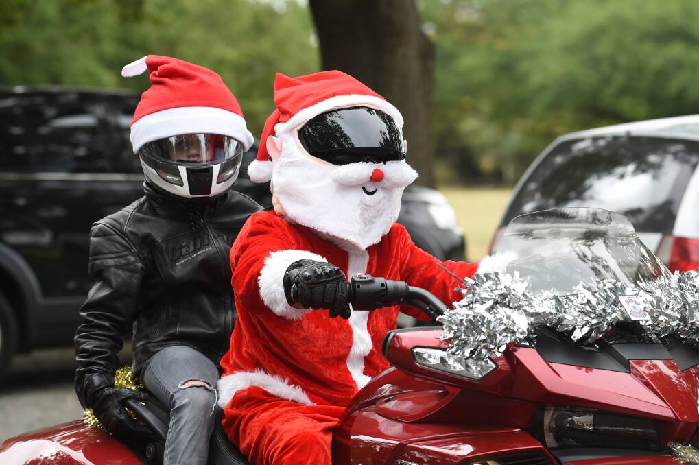 SANTA'S HELPERS: Jayden Bell, 10, and David Bell from Ballan were among more than 300 riders to take part in the annual toy run organised by the Central Highlands Branch of the Ulysses Club. Picture: Kate Healy