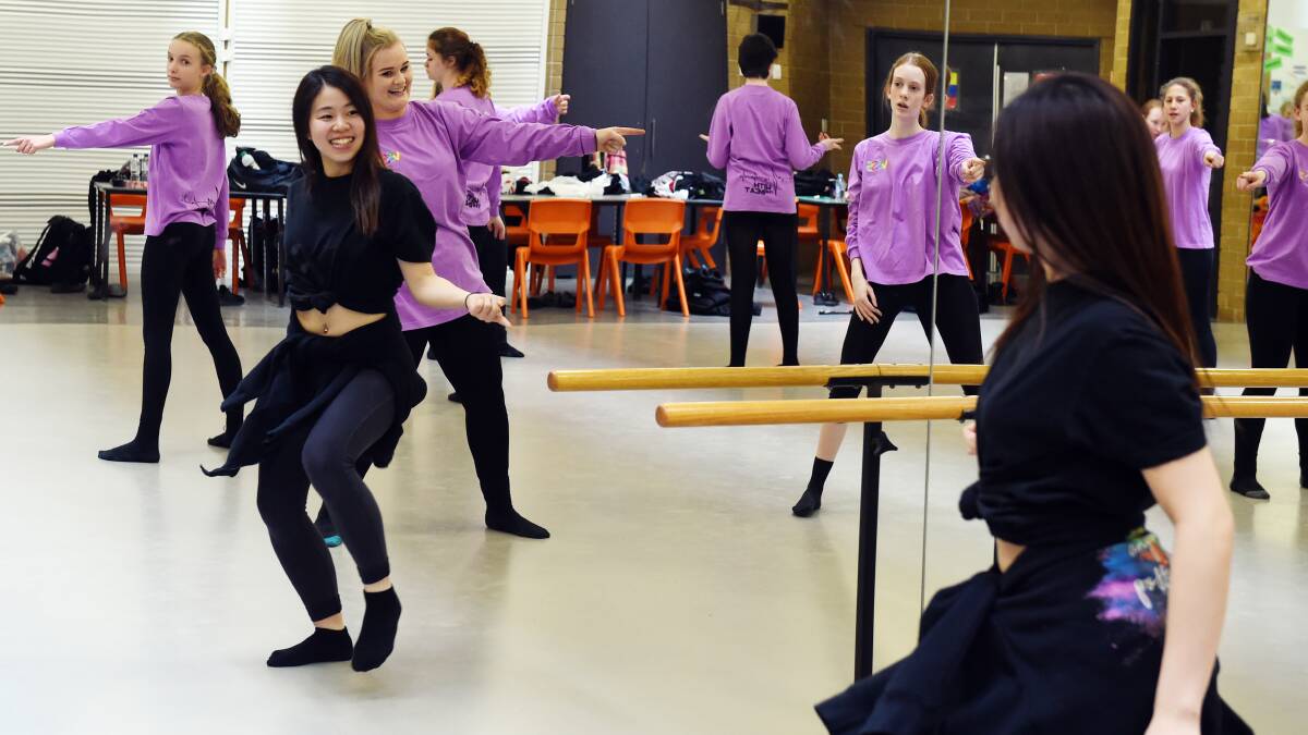 FUN: Ensemble dancer Sayaka Miyajima practices with members of the massed dance troupe from Mount Clear College as they prepare to join thousands of other students for the Victorian State Schools Spectacular show With The Beat. Picture: Kate Healy