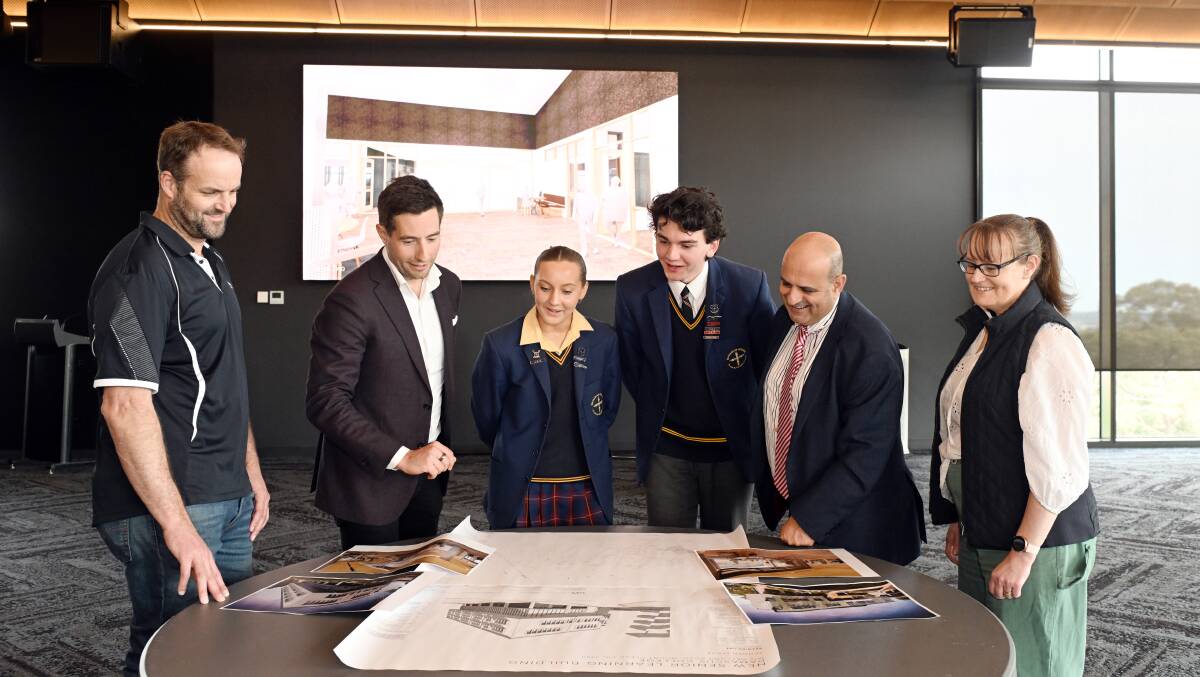 Mick Page, Chris Cogdon, Paris Govan, Lucas Wells, Steven Mifsud and Lucy O'Beirne inspect plans for the new Damascus College senior learning precinct. Picture by Kate Healy