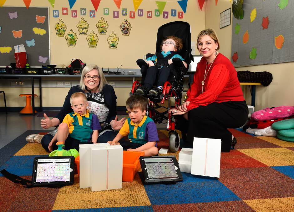 DONATION: BSS leading teacher digital technologies Caitriona Ferrer and State Schools' Relief chief Sue Karzis with students Noah, Elijah and Oisin who will benefit from the donated iPads. Picture: Adam Trafford