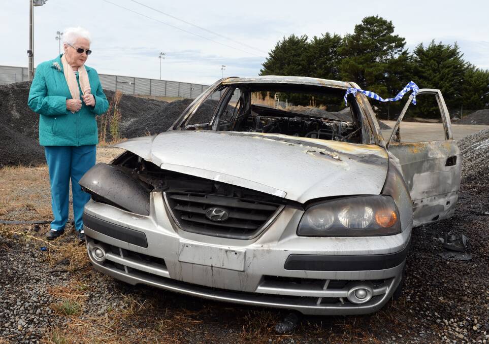 GUTTED: Nell Hanrahan, 91, surveys the wreck of her beloved Hyundai Elantra which was stolen on Friday and torched in Delacombe early Sunday morning. Picture: Kate Healy