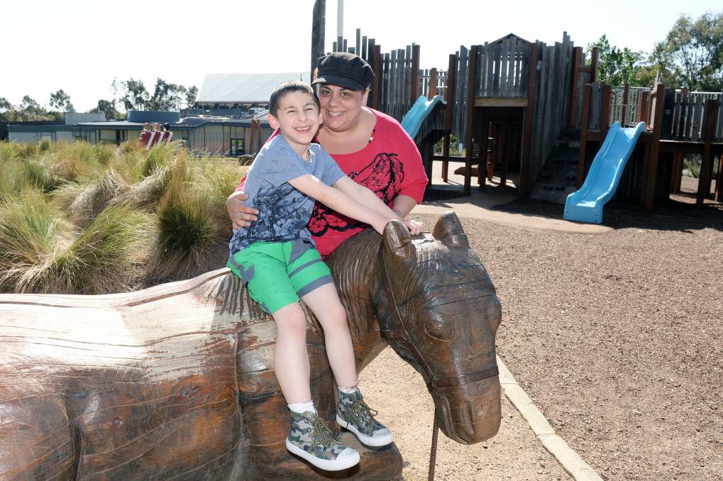 LOVE: Kelly Orsini and son Xander, 7, take a break from playtime at Eureka Park. Picture: Kate Healy