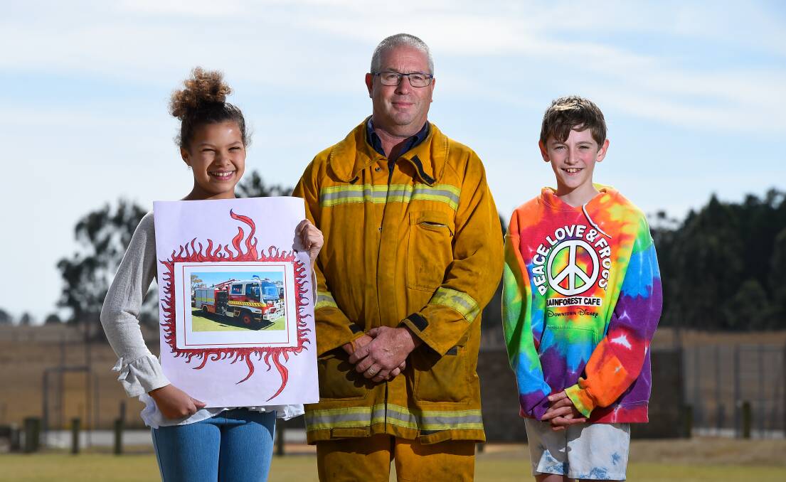 DONATION: Haddon Primary School captains Isabella Louw and Kiarn Dark with Haddon CFA captain Graeme Morris after students decided to donate money to the CFA instead of holding an end-of-term icecream party. Picture: Adam Trafford
