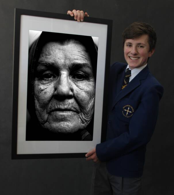 FACES: Photographer Luka Spoljaric with a photograph of his aunt, one of three pieces of work he submitted as a folio in the ATOM award. Picture: Anne Griffin