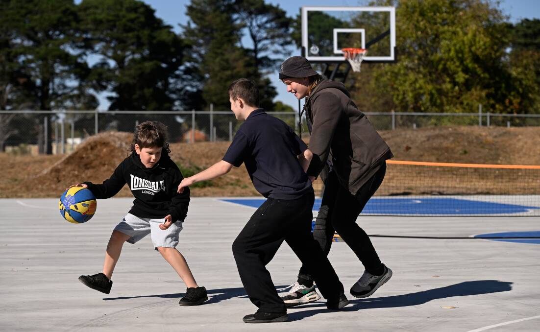 Kyden, Seth and Jayden play basketball on the new court at Yuille Park Community College's McKenzie Drive campus. Picture by Adam Trafford