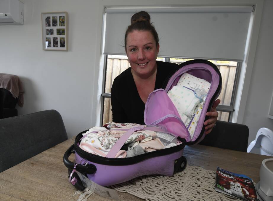 MAKING A DIFFERENCE: Hannah Turner with a bag from Hope in a Suitcase packed for a baby going in to foster care. Picture: Lachlan Bence