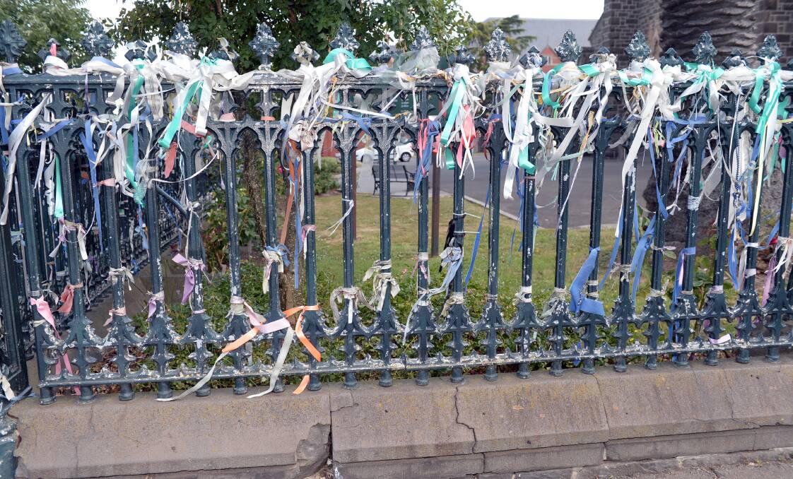 Damage can be seen to the paint and footings of the historic St Patrick's Cathedral fence. Picture by Kate Healy