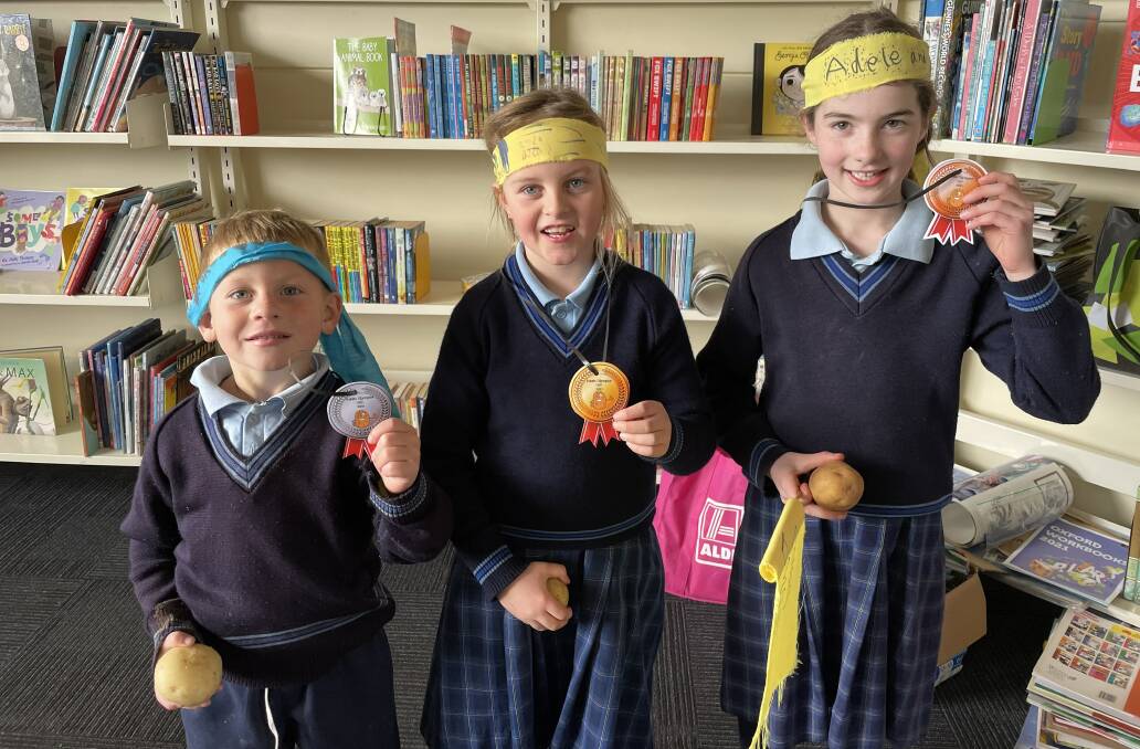 WINNERS: St Brendan's pupils Billy, Felicity, Adele with their potato athletes and medals won during the Dunnstown Potato Olympics. Pictures: supplied