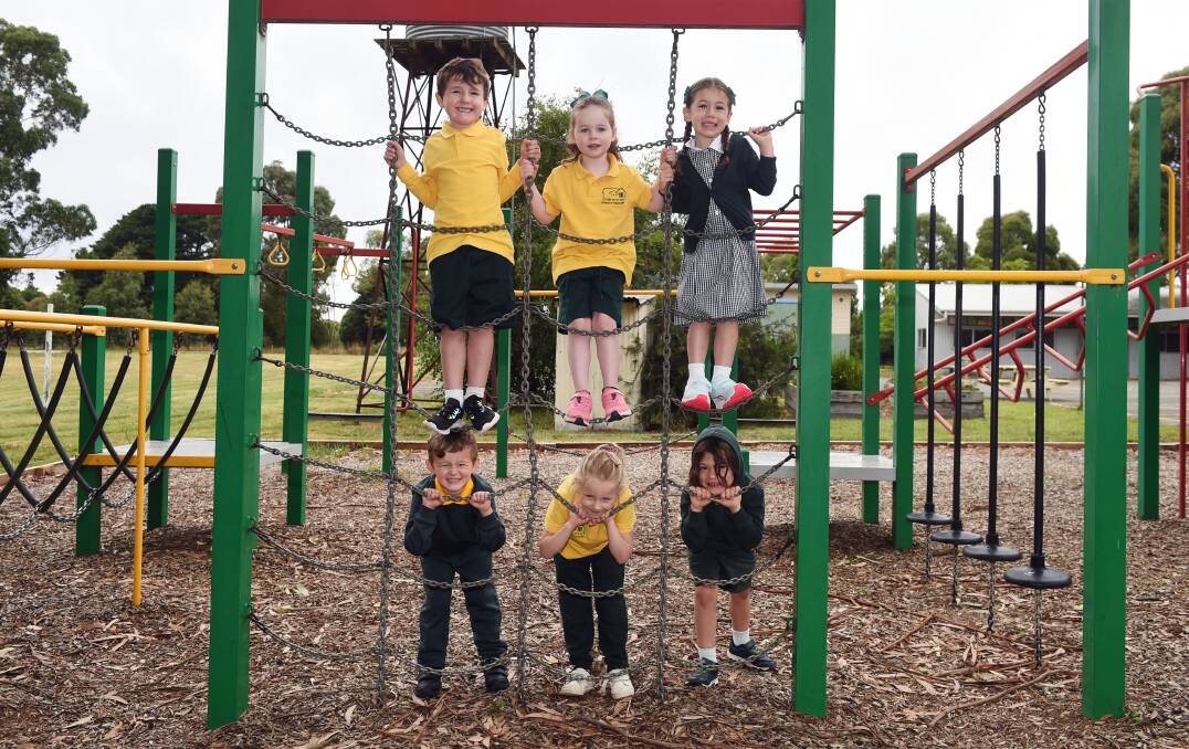 CLIMBING UP: Warrenheip Primary's prep students (top) Magnus, Brooklyn, Lillian and (bottom) Tyson, Scarlett and Logan check out the playground on their first day. Picture: Kate Healy