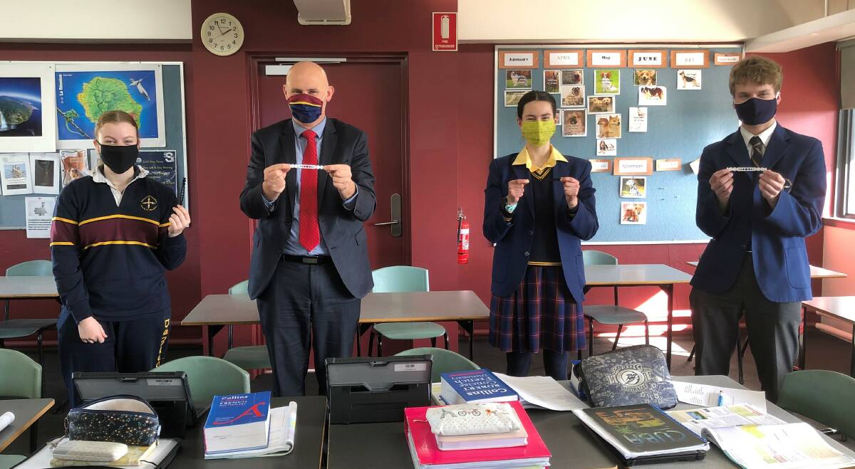 MASKED: Kiara Dowie, principal Matthew Byrne, Mia Lepair and Patrick O'Beirne model the masks and ear protectors made at Damascus College. Picture: supplied