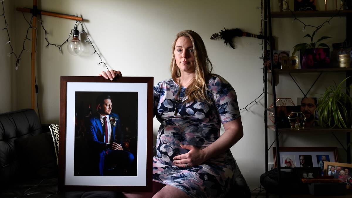 GRIEVING: Cassandra Hall with a picture of her late husband Alex, who died in February from an anaphylactic reaction to barramundi. Picture: Adam Trafford