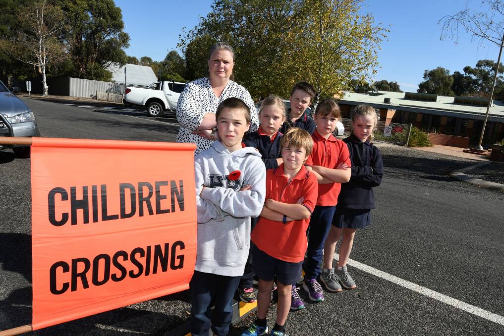 THEN: Will, Kane, Hannah, Ava, Ruby, Will, and school council president Kiristy Branson on the crossing outside the school before a school crossing supervisor was approved. Picture: Lachlan Bence