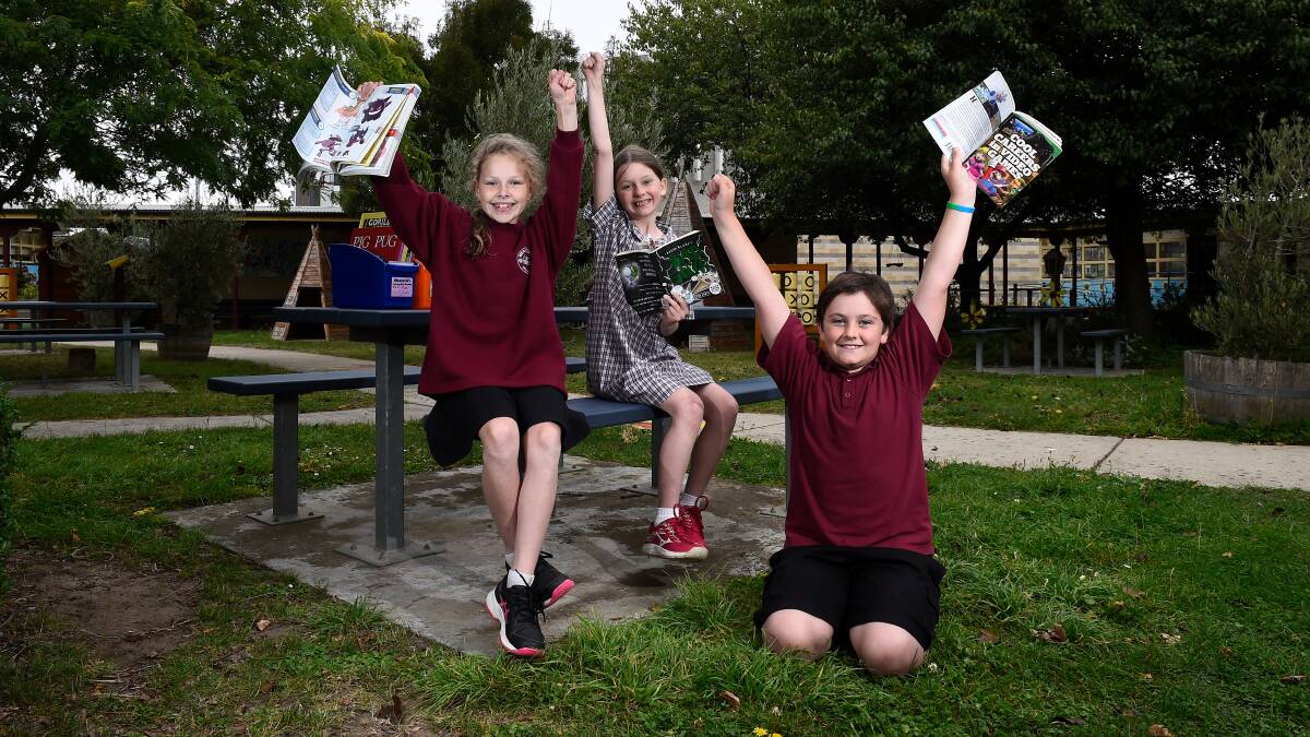 READERS: Shantell, Vivien, Declan celebrate Wendouree Primary School's improvement in NAPLAN numeracy and literacy results. Picture: Adam Trafford