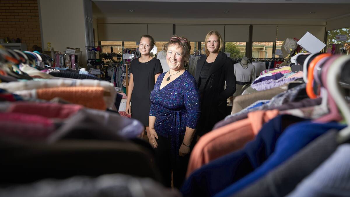 RACKS: Sarah Bendixen, Sussan Wyatt and Jessica Post with some of the fashion finds at St Matthew's Op Shop. Picture: Luka Kauzlaric