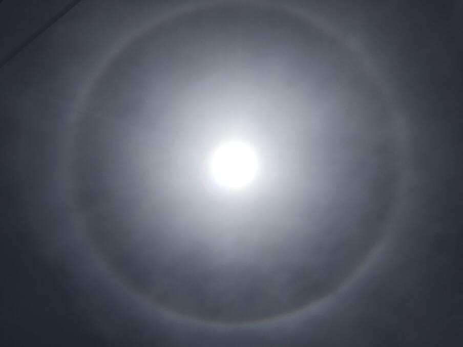 HALO: The sun's light reflecting through a layer of thin ice-laden cloud formed a rainbow circle around the sun.