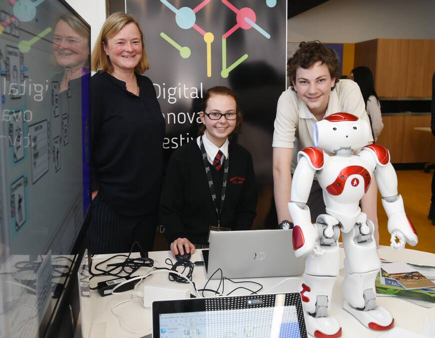 FUTURE GUIDE: Visit Ballarat's Serena Eldridge with Mt Clear College students Gwen Anderson and Ronan Anderson and their humanoid robot guide. Picture: Kate Healy