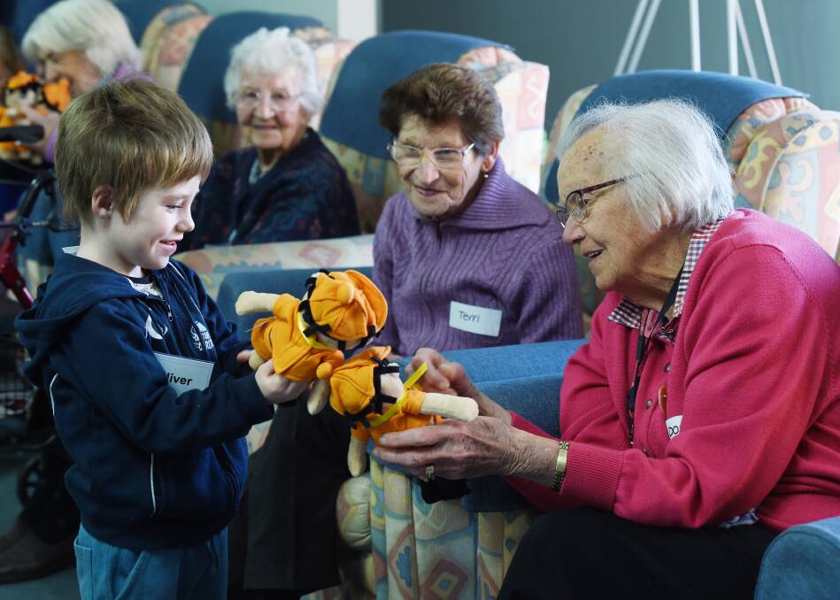 GENERATIONS: Oliver makes friends with Terri and Doreen at Pineview Residential Care. Picture: Kate Healy