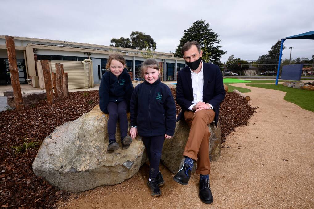 MORE FUN: Georgia, Nevaiya and Caledonian Primary School principal Ben Moody enjoy the groundworks completed around the school during lockdown. Picture: Adam Trafford