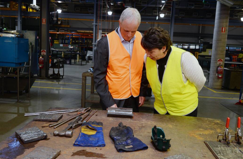 Federation University TAFE's Bill Mundy shows Buninyong MP Michaela Settle some work in the welding area. 