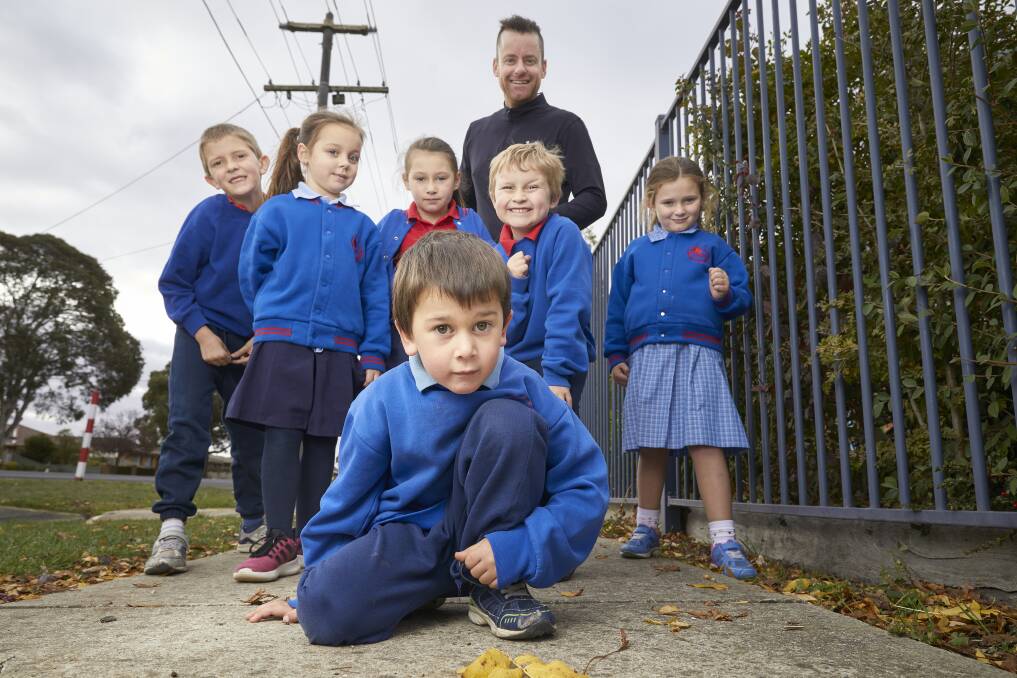 WALKING: Forest Street Primary School pupils (back L-R) Cam, Ruby, Tanika, Jackson, Pip and (front) Noah with PE teacher Justin Simpkin get in some practice on the paths around their Wendouree school ahead of Friday's national Walk Safely to School Day. Picture: Luka Kauzlaric