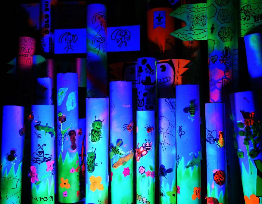 BLUE POLES: In a workshop with local artist Lou Callow, Ballan cubs and joeys created the work Totem Poles using fluoro paper, black texta and highlighter pens on cardboard rolls for the first Black Nite Black Lite event last year. 