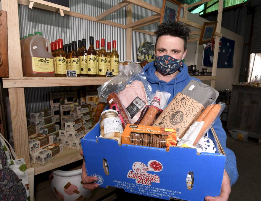 HAMPER: Ballarat Mushroom Farm's Tanya Lunn with a selection of goods from local producers that will be put in 'survival packs' for local clubs. Picture: Lachlan Bence