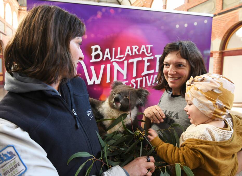 KOALA: Wildlife Park keeper Julia Leonard, Stephanie Durand and baby Ella Duclos at the Ballarat Winter Festival launch. Picture: Lachlan Bence