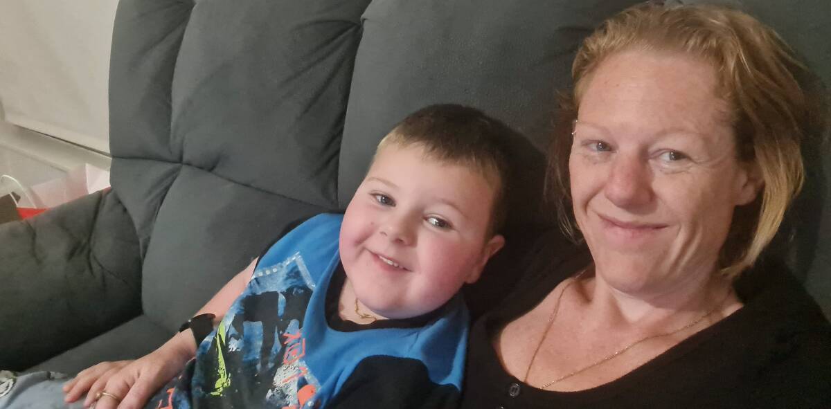 RELAX: Caleb spend time on the couch with mum Michelle. Picture: supplied