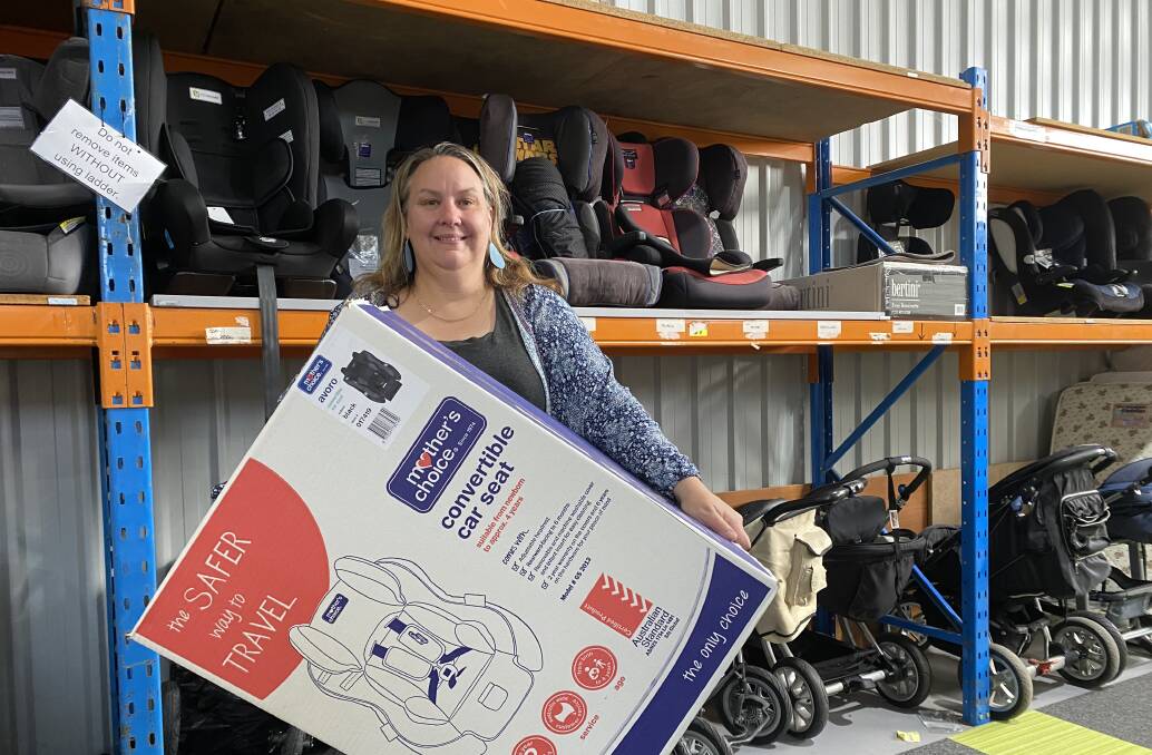 GENEROUS: Trinsa Lewis with some of the new and used car seat stock at Eureka Mums' Sebastopol warehouse. 