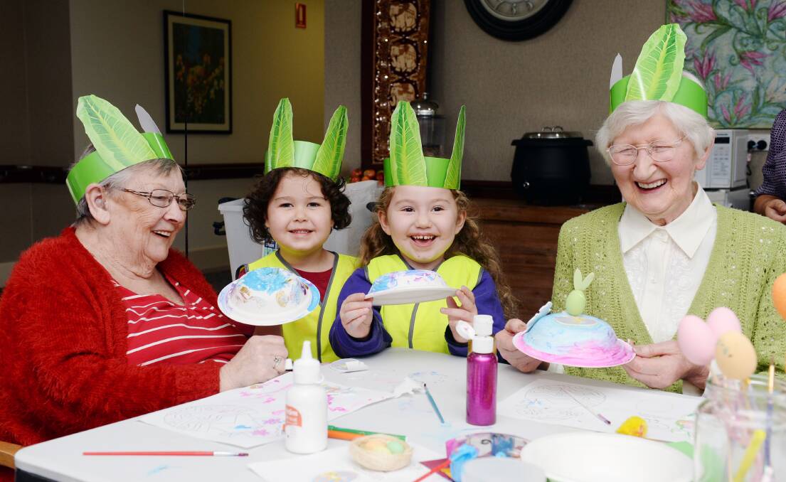Bupa Ballarat aged care residents Coral Lester and Alison James have been to every visit over the past 12 months with children including Rory, 4, and Zahra, 4, from the nearby Journey Early Learning Centre. Picture by Kate Healy