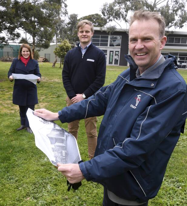 PLANS: Wendouree MP Juliana Addison, H. Troon project manager Riley Pascoe and Delacombe Primary School principal Scott Phillips look over the plans for the new basketball stadium ahead of construction starting on Monday. Picture: Lachlan Bence