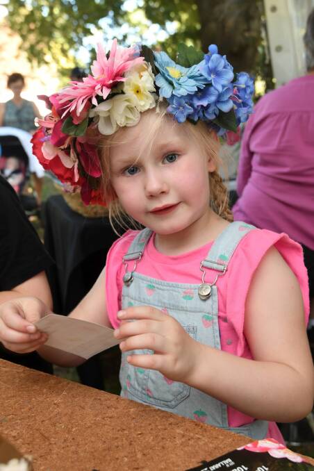 CROWN: Evie Gull gets to work making her paper pot to plant a herb seedling in at the BotaniKIDS planting activity.