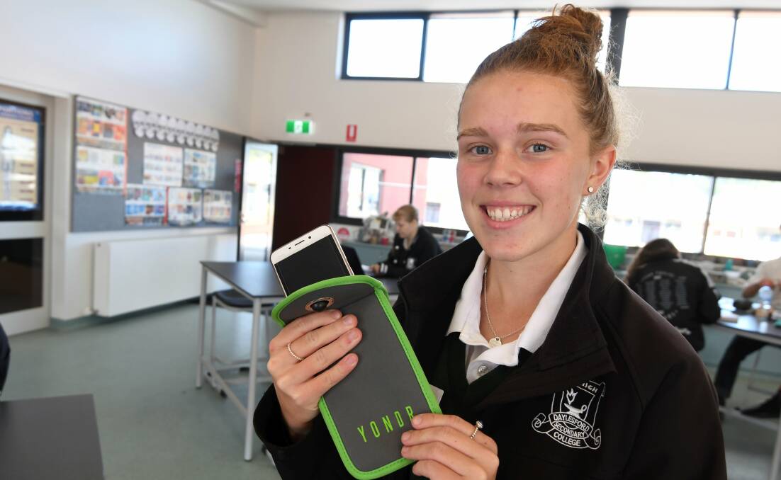 LOCKED: Daylesford Secondary College student Lucinda Lowe with her phone in a phone lock, which the school trialled last year. Picture: Lachlan Bence