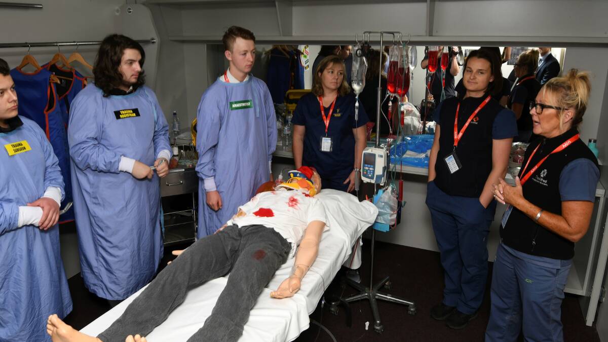 NEW JOBS: Students role-play as doctors and nurses treating a trauma patient in an emergency department under the watchful eye of Alfred Hospital ED staff. Picture: Lachlan Bence