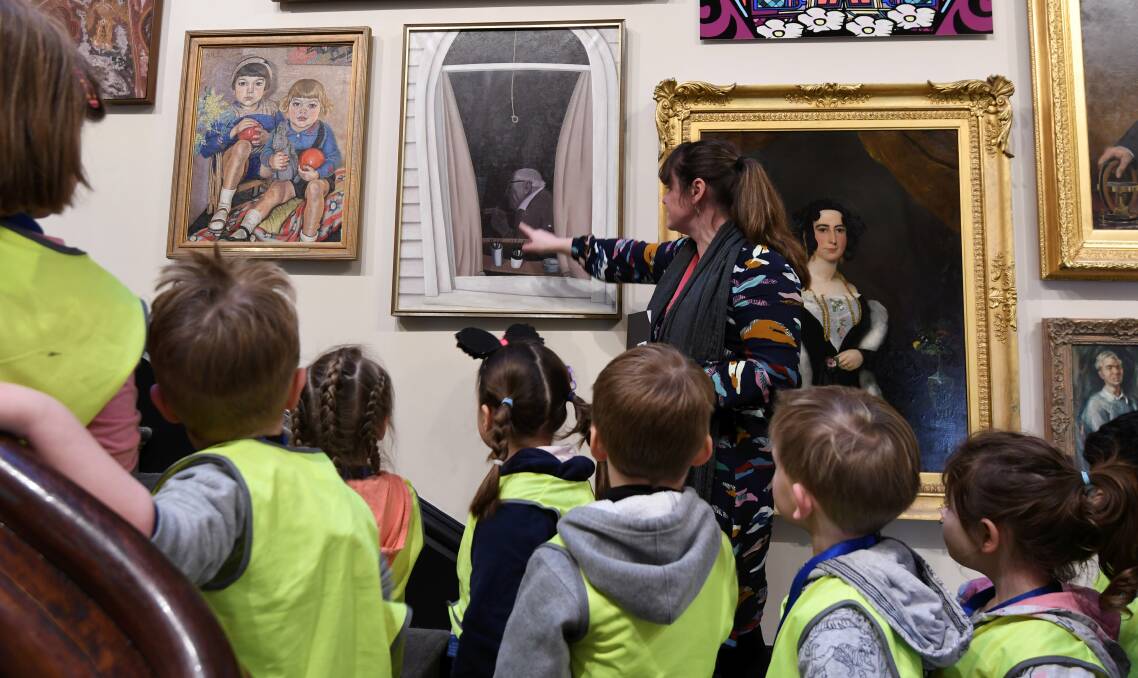 ARTY: Children from Federation University Children's Centre look at the faces of the paintings with Art Gallery of Ballarat education officer Kate Gorman. Picture: Lachlan Bence 