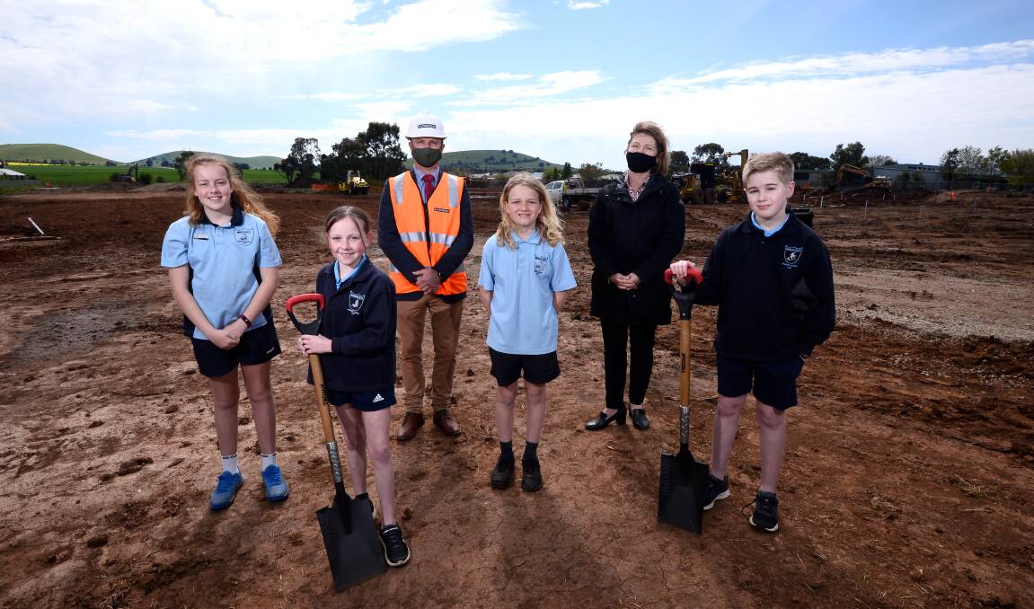 NEW SITE: Miners Rest Primary pupils Addy, Zienna, Jarvis and Alex with principal Dale Power and assistant principal Kylie Nissen inspect groundworks on the school expansion site next to the current school. Picture: Adam Trafford