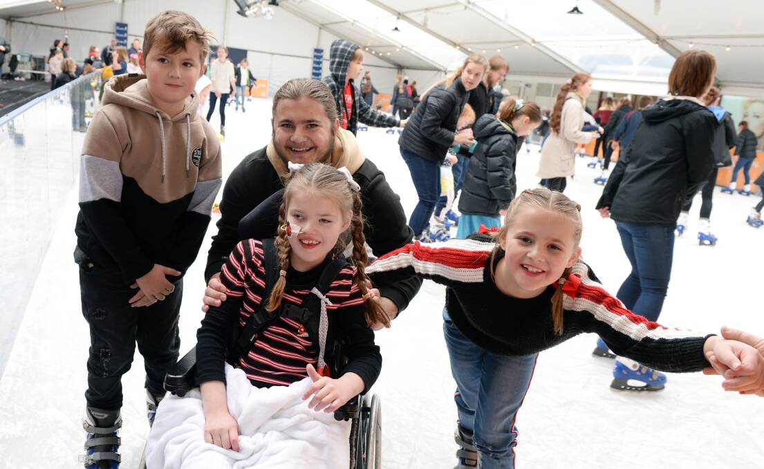 COOL: Harrison, Blake, Sienna and Grace Corbell have some fun together as a family at the pop up ice skating rink. Picture: Kate Healy