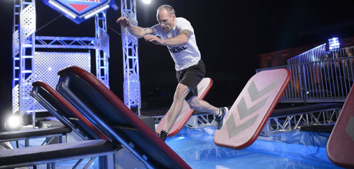 NINJA LEAPS: Clunes circus performer and pupeteer Neal Holmes takes on the quintuple step of the Australian Ninja Warrior course.