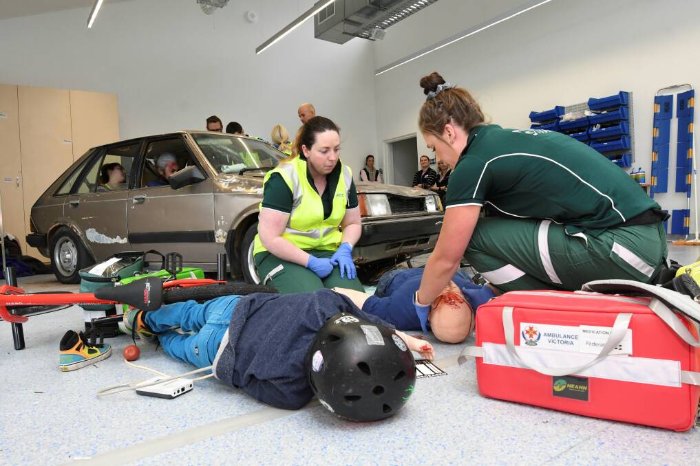CARNAGE: Students Megan Watts and Ashleigh Knight treat two of the victims. Pictures: Lachlan Bence