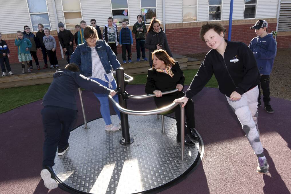 FUN TIMES: Wendouree MP Juliana Addison has a spin on the carousel courtesy of Ballarat Specialist School students Jeremy, Jasmine, and Alexa. Picture: Lachlan Bence
