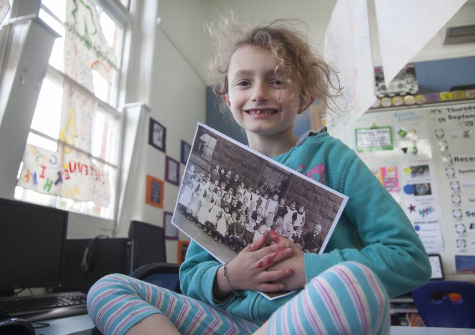 NEW AND OLD: Grade one pupil Eleanor, 7, clutches a Bungaree Primary School class photo from 1900. Pictures: Mark Smith