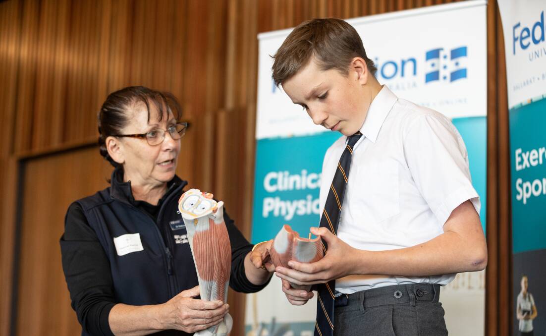 Deborah Pascoe of Federation University gives student Xavier Mangan a quick lesson in anatomy at the Damascus College STEAM Expo. Picture: Luke Hemer.