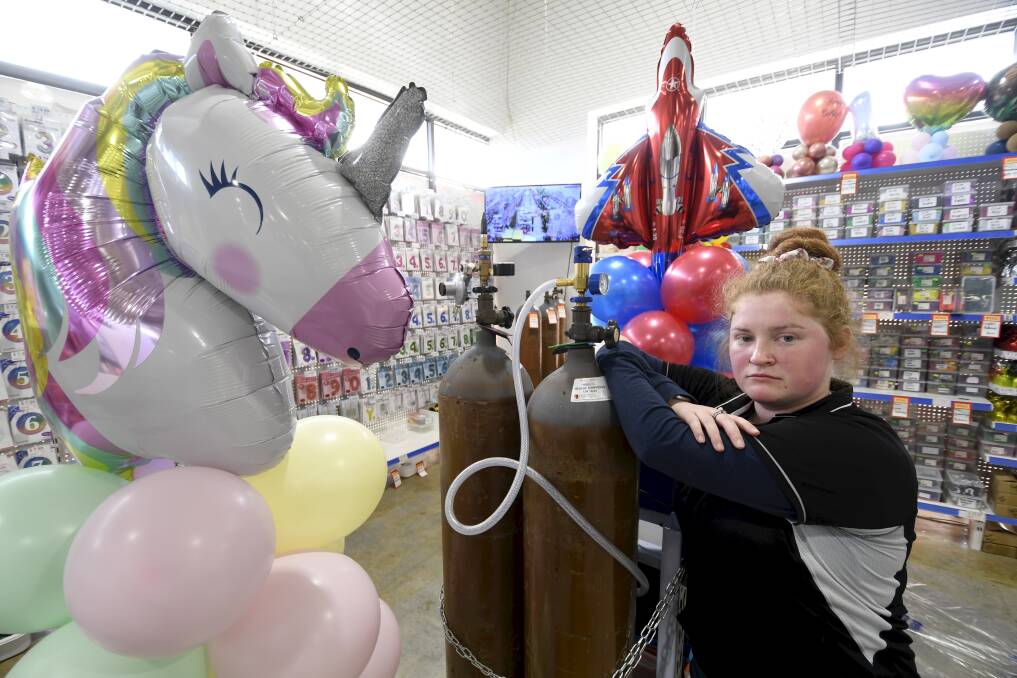 SHORTAGE: I Love This Shop Delacombe sales assistant Amy Redmond with balloon towers made without helium, because a global shortage of helium is leaving balloon lovers deflated. Picture: Lachlan Bence