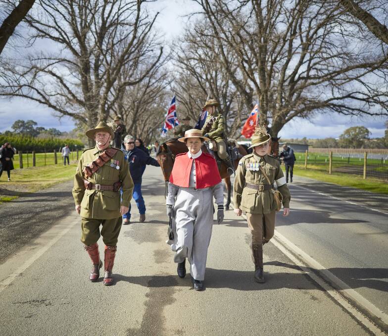 MARCH: The centenary procession along the Bacchus Marsh Avenue of Honour. Pictures: Luka Kauzlaric
